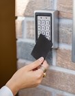 Attaching card to the electronic reader to access the office or apartment, close-up. Card entry, personal identification, keyless access, modern technologies concept